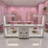 3 Side view of pink L-shape wooden manicure table - Nova