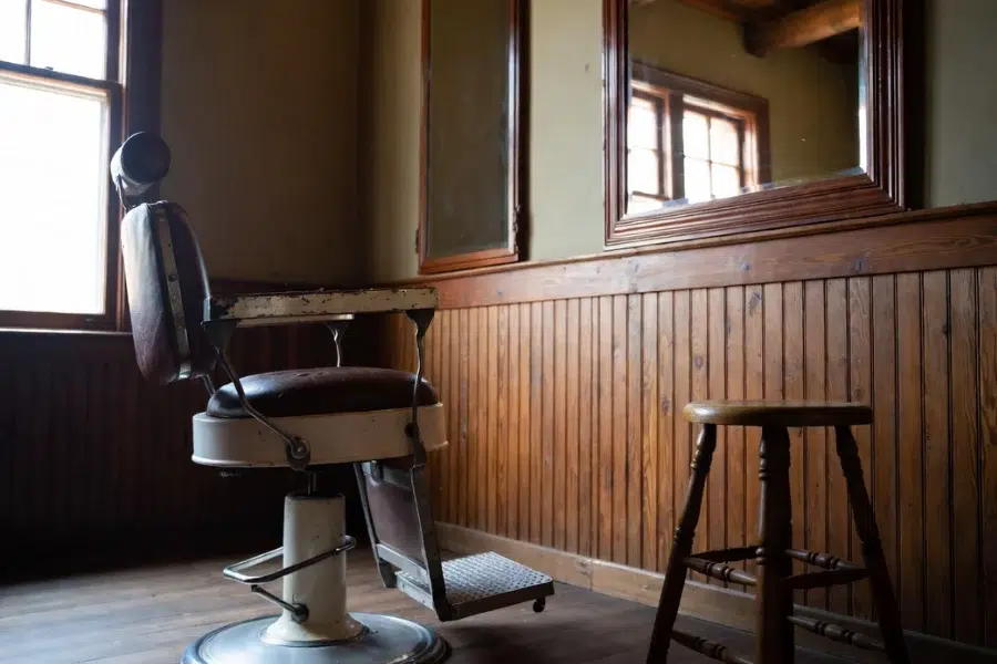 Early examples in The Evolution of the Modern Hair Salon Chair showing simple barber seating