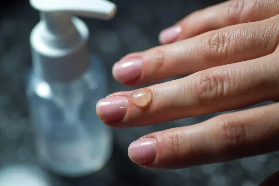 Hydrating nails with cuticle oil for strong and healthy nails. Nail care tip for every client.