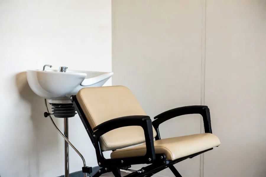 Portable hair styling chair and shampoo bowl setup for a mobile beauty salon, perfect for hair services on the go.