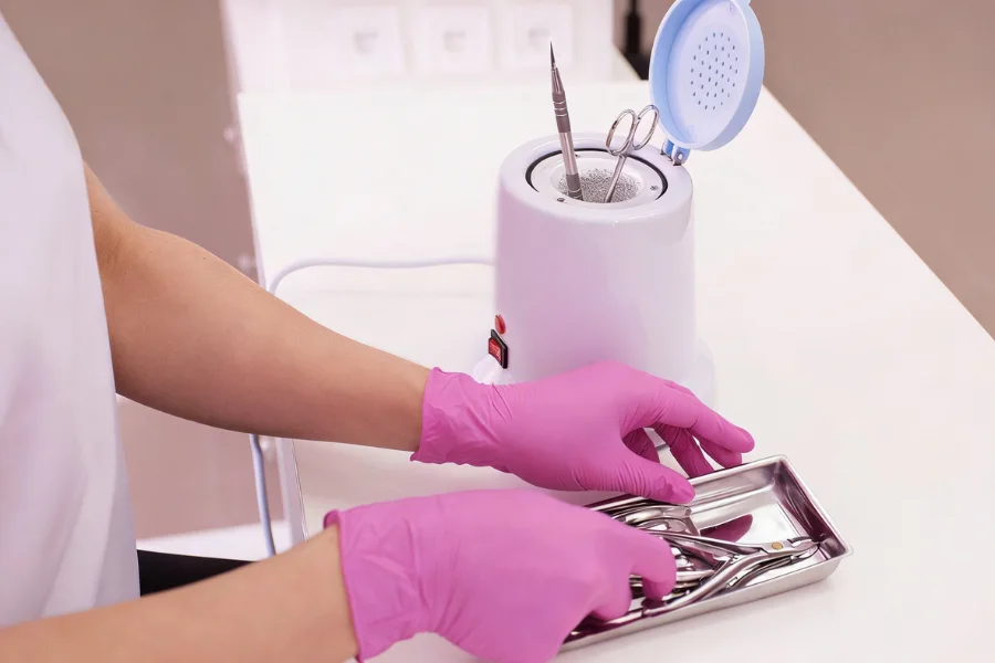 nail salon metal tools disinfecting in sanitizer solution