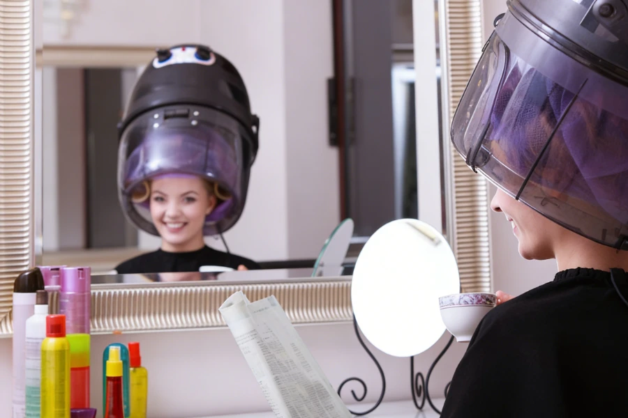 hooded hair dryer used for roller set styling in a salon