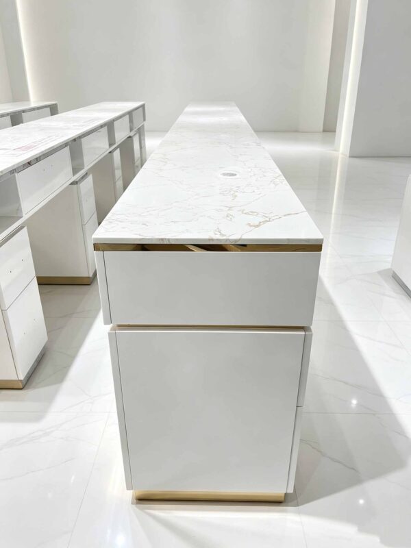Luxury white manicure table with marble countertop and gold trim, multi-drawer nail salon station